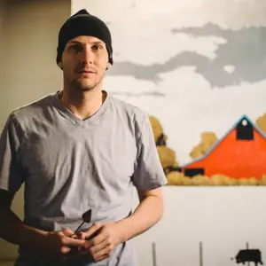 image of Jeff Puch standing in front of a painting