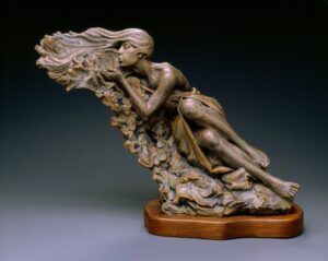 Sculpture by Ben Hammond of a beautiful woman blowing a gentle breeze