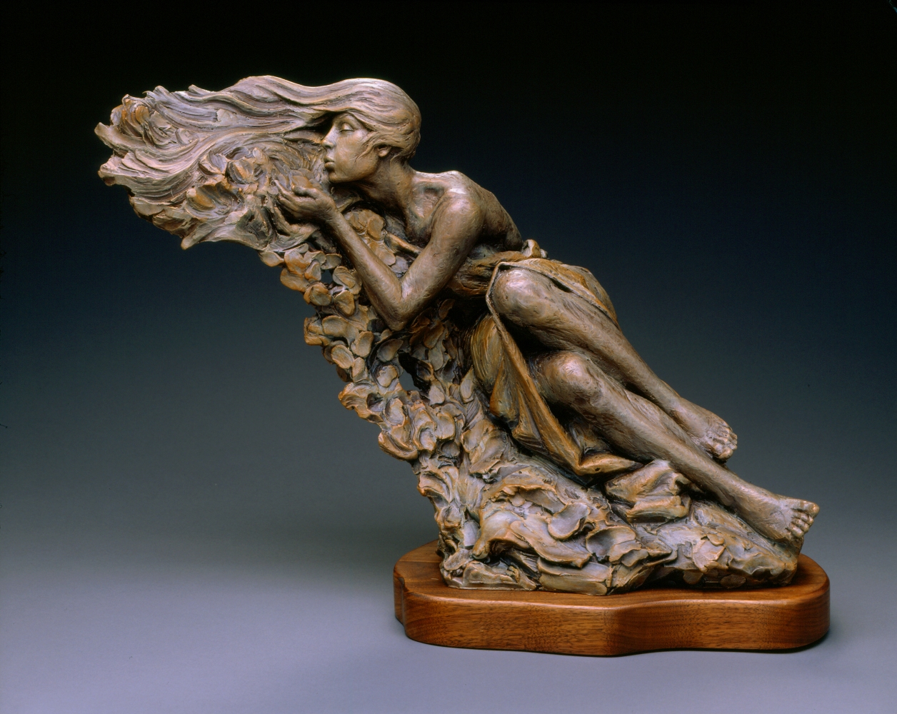 Sculpture by Ben Hammond of a beautiful woman blowing a gentle breeze