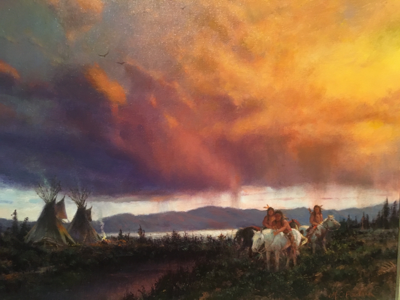 painting by MC Poulson of a native american village at the eddge of a lake. THere are three native hunters on horseback under a dramatic evening sky