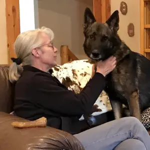 image of jullie chapman petting a german shepherd dog