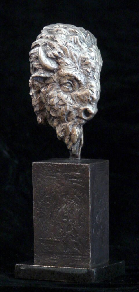 bronze sculpture of a buffalow head atop a cube base