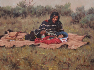 native american gazing happily at baby laying on a blanket