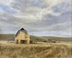 painting of a rustic barn in a field with mountains in the backdrop