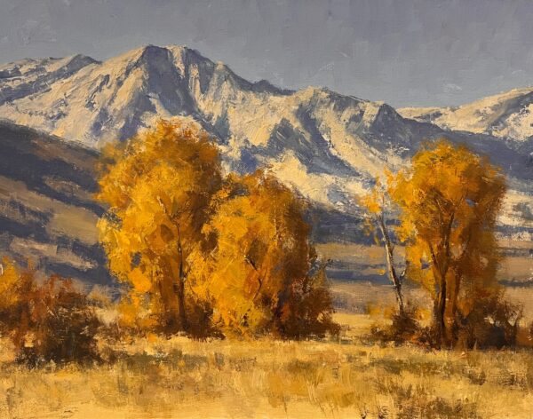 painting of golden hued tress in front of a snow capped mountain backdrop