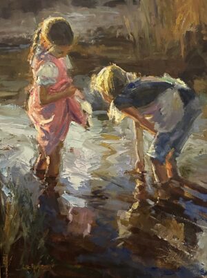 2 young girls playing in a stream