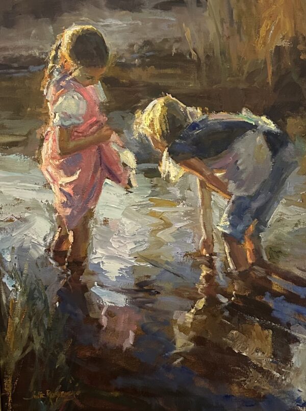 2 young girls playing in a stream