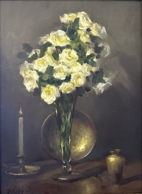 White flowers in a vase in front of a brass plate