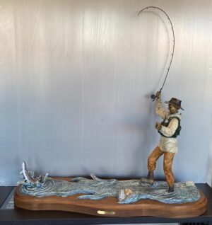 sculpture of fisher fly fishing and getting a strike