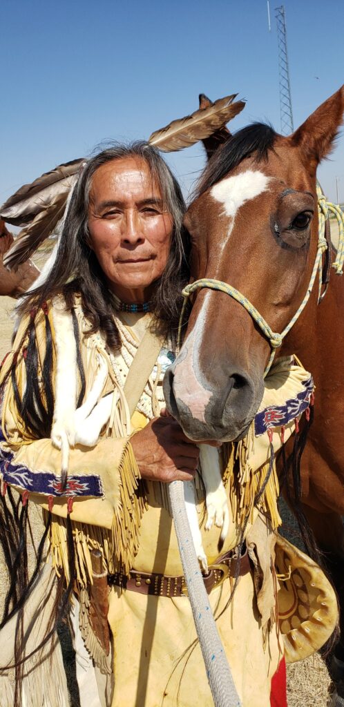 closeup photo of Thomas White standing next to a horse
