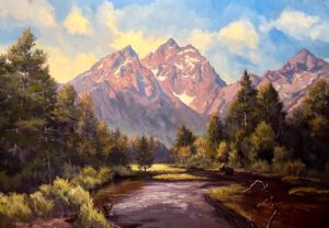 A realist landscape painting of a winding river flowing through a dense forest of evergreen trees, with a solitary moose standing along the right riverbank. In the background, a majestic, jagged mountain range resembling the Grand Tetons rises sharply into a blue sky, its snow-dusted peaks illuminated by a warm, golden sunset glow.