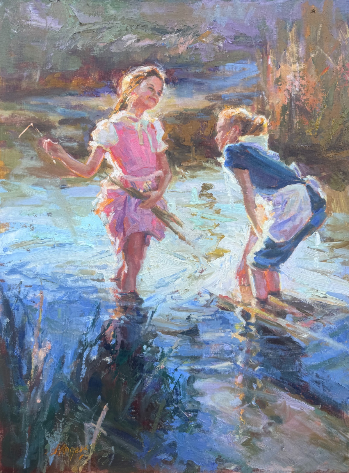 Two young girls wading in a stream and talking